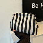 Striped women's handbag with vertical stripes and contrasting color shell bag