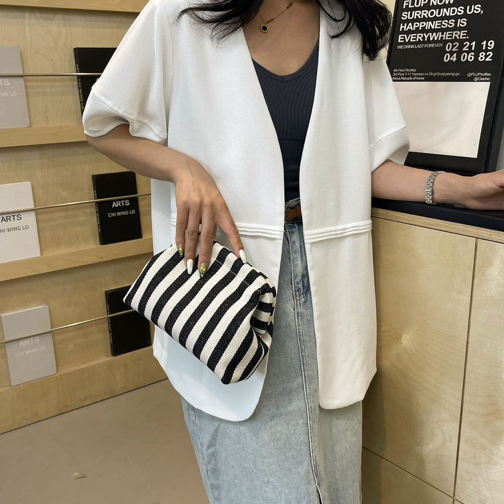 Striped women's handbag with vertical stripes and contrasting color shell bag