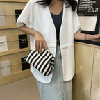 Striped women's handbag with vertical stripes and contrasting color shell bag