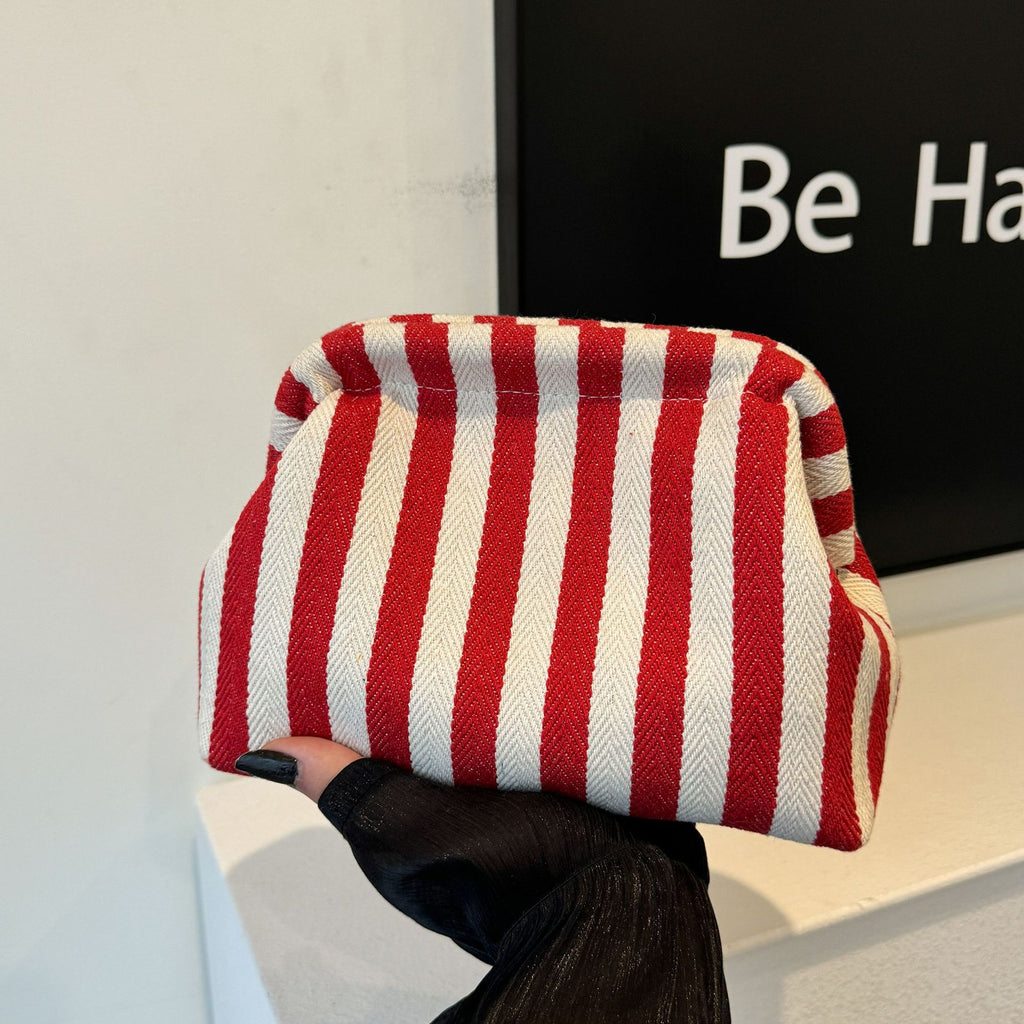 Striped women's handbag with vertical stripes and contrasting color shell bag