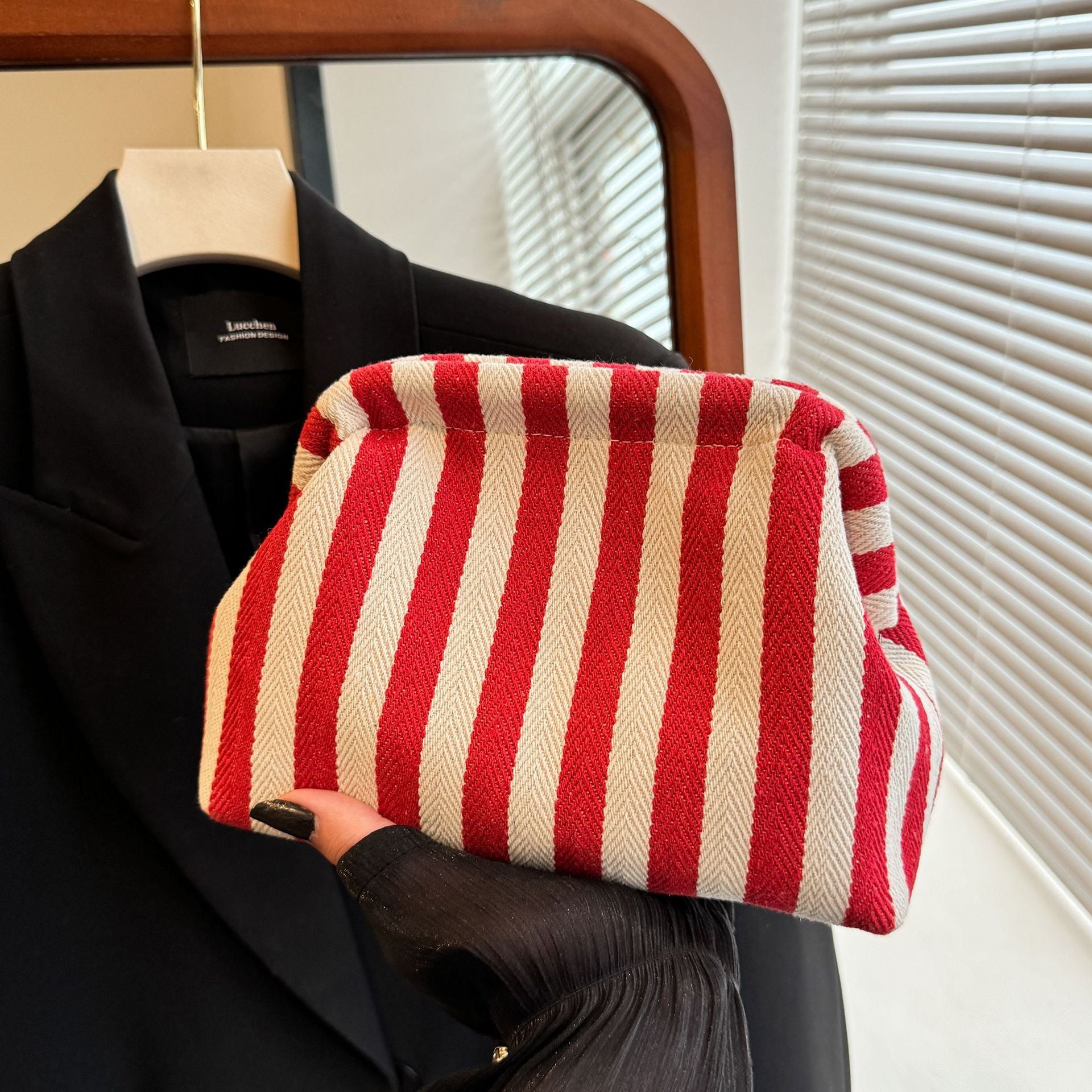 Striped women's handbag with vertical stripes and contrasting color shell bag